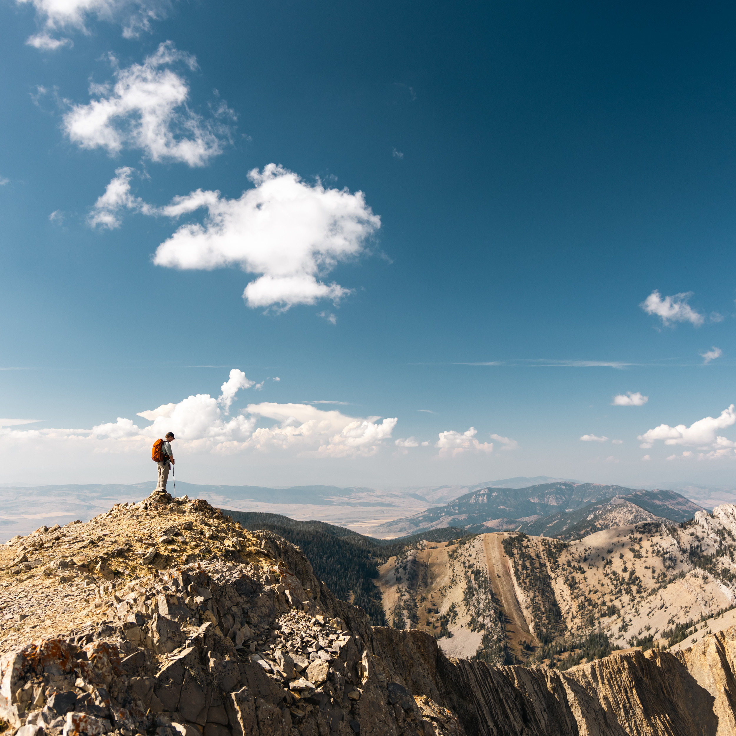 Hiker at the top of the bridger mountain range